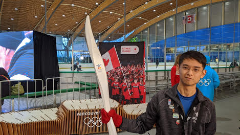 A staff member of the Richmond Olympic Oval demonstrating a torch used in the 2010 Winter Olympics