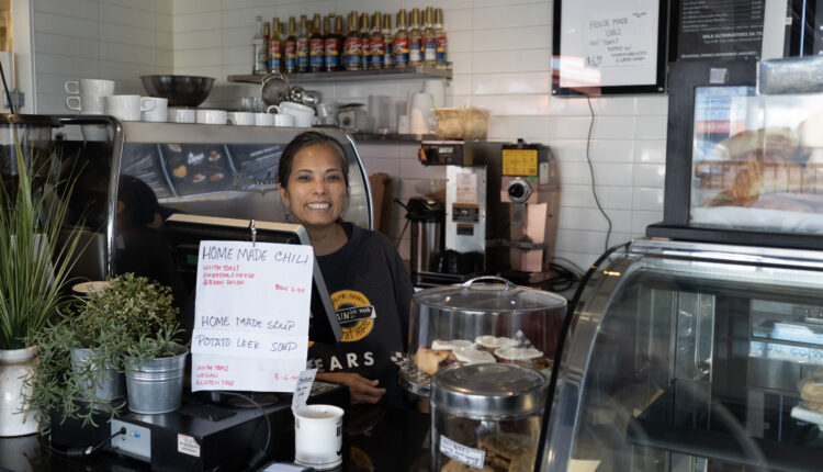 Owner of Roots Cafe Ethel Garcia poses behind the counter of her store.