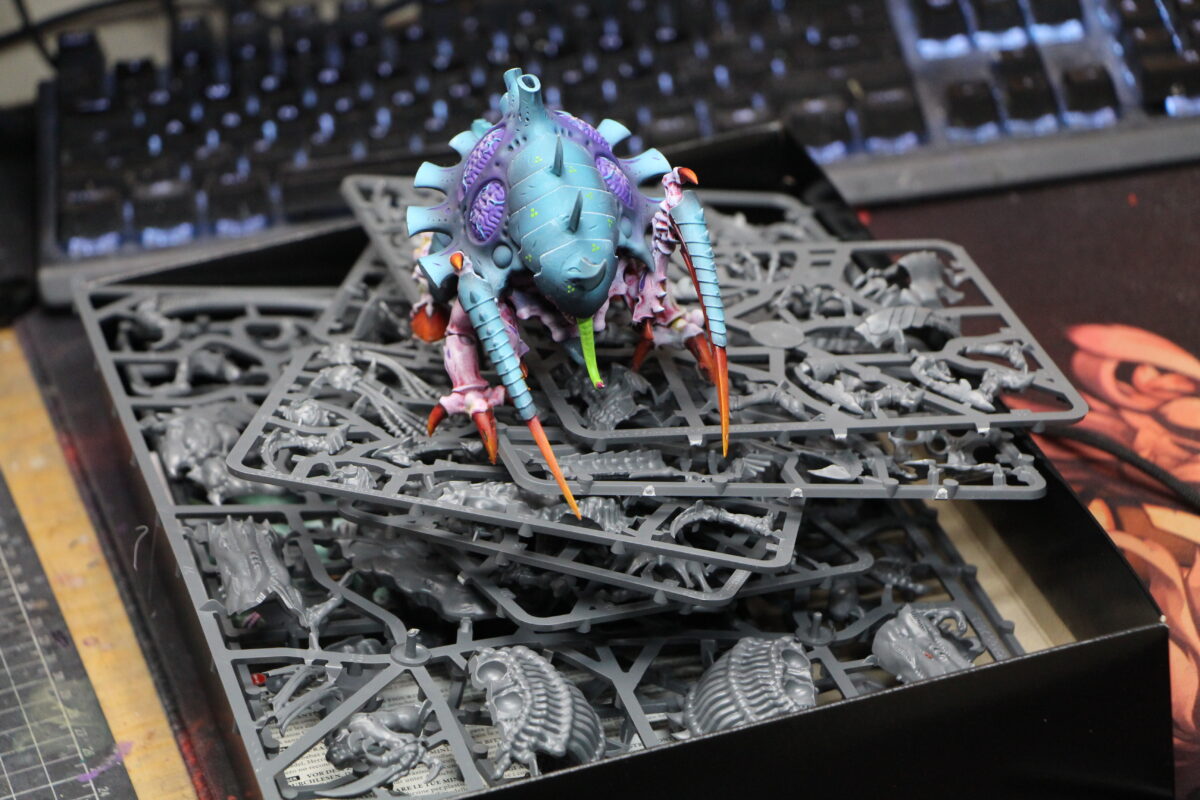 Sprues of Tyranid models with an assembled Tyranid sitting on top