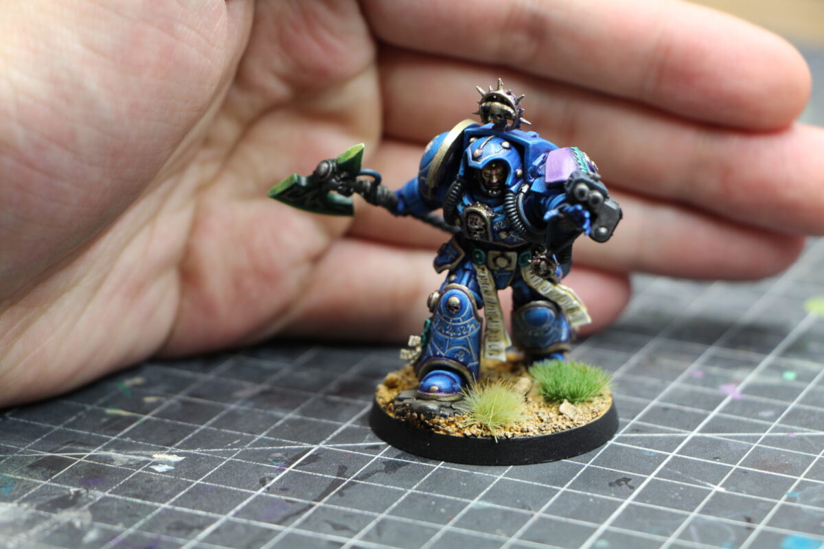 A Space Marine terminator librarian next to a hand