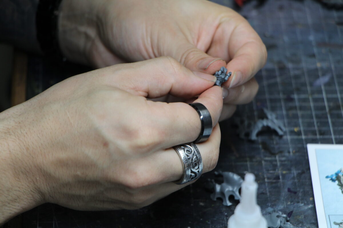 Jim Vesal gluing together Tyranid models for a client