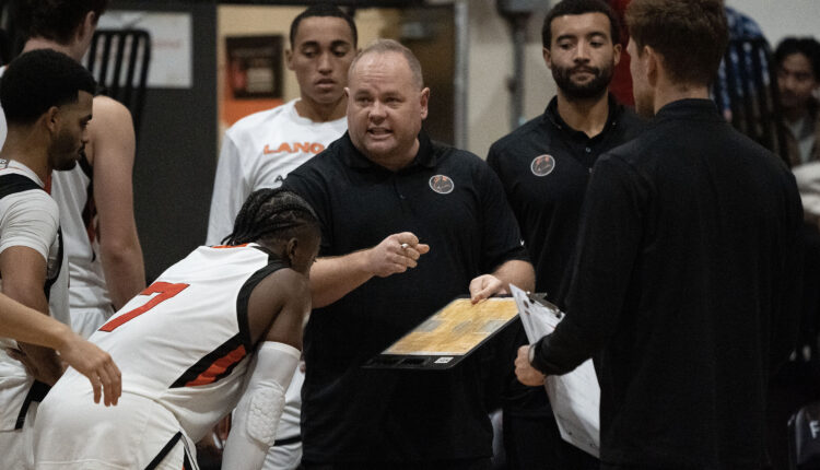 Men’s coach Cassidy Kannemeyer talks to team surrounding him.