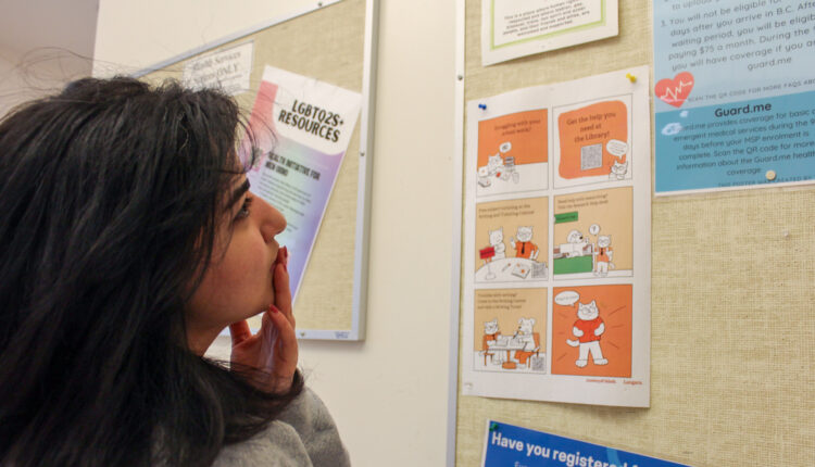 a student looks at a bulletin board at Langara College